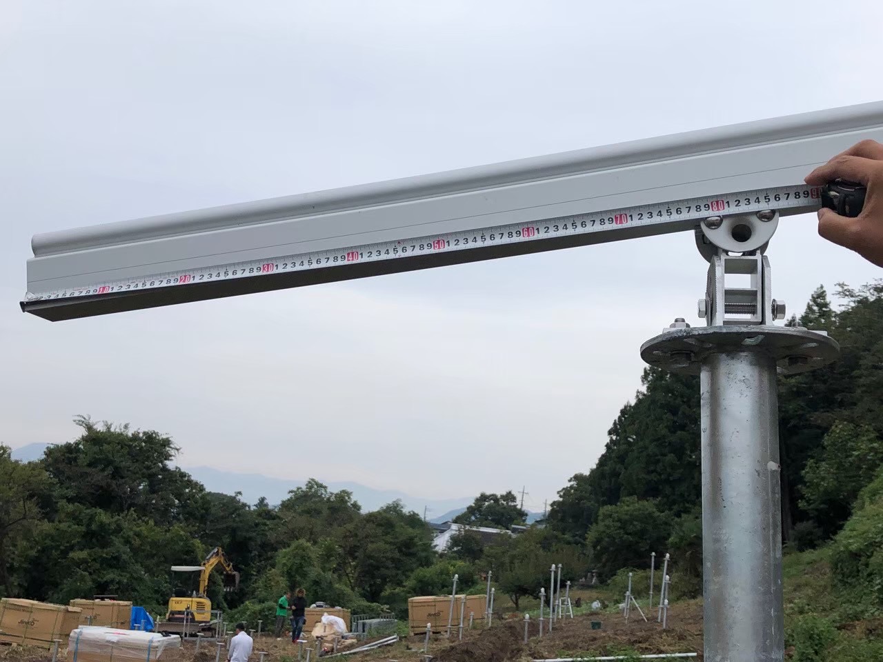 野立て太陽光発電の架台寸法と角度を確認している様子